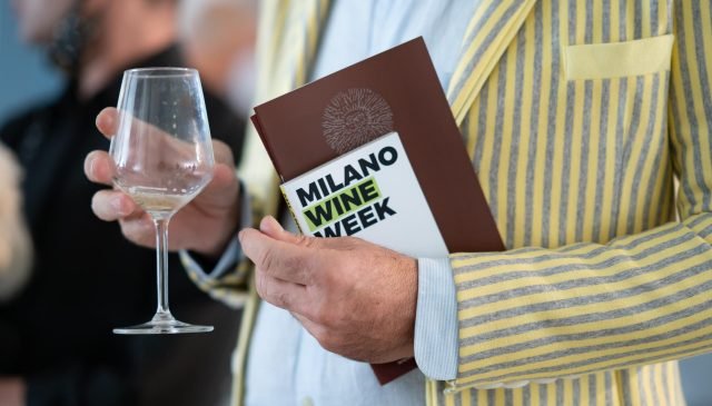 un uomo con un bicchiere alla milano wine week