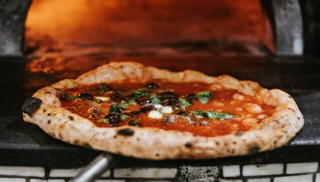 a pizza taken from an oven