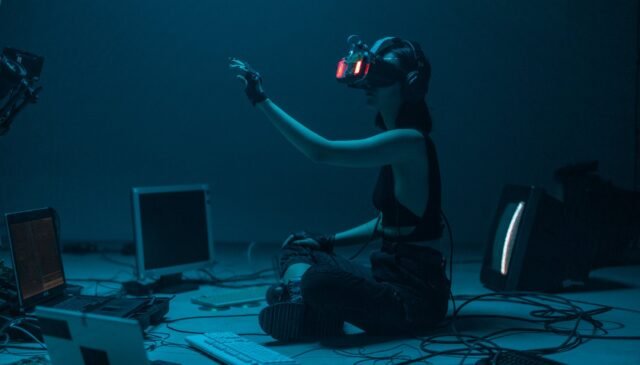 a woman in a tank top using a vr headset