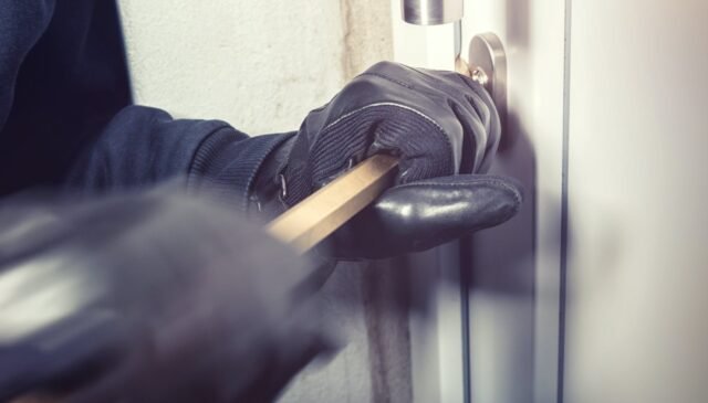 person opening a door with a bar