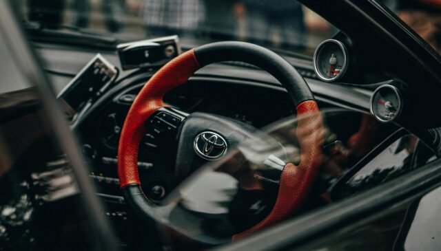 black and red toyota car steering wheel