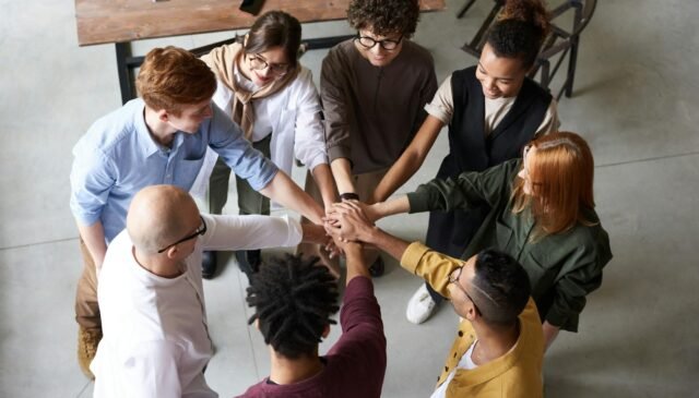 photo of people holding each other s hands