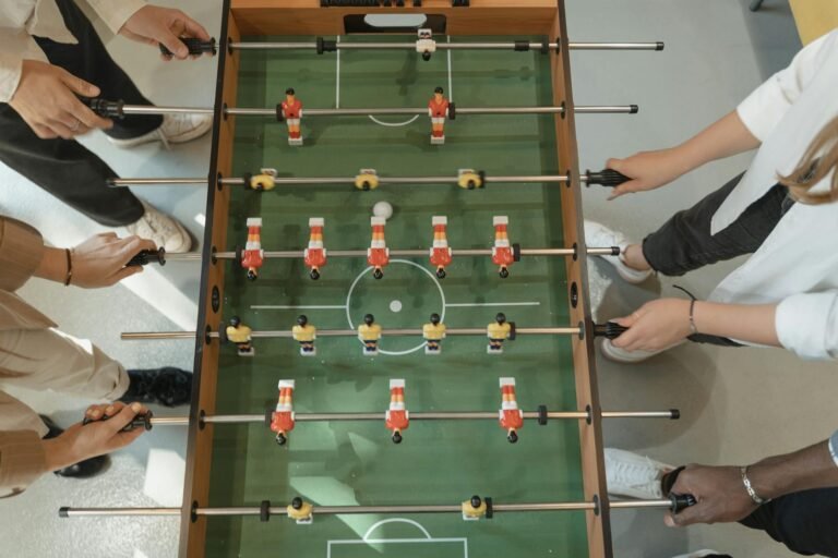 group of friends playing foosball