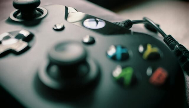closeup photography xbox one black controller