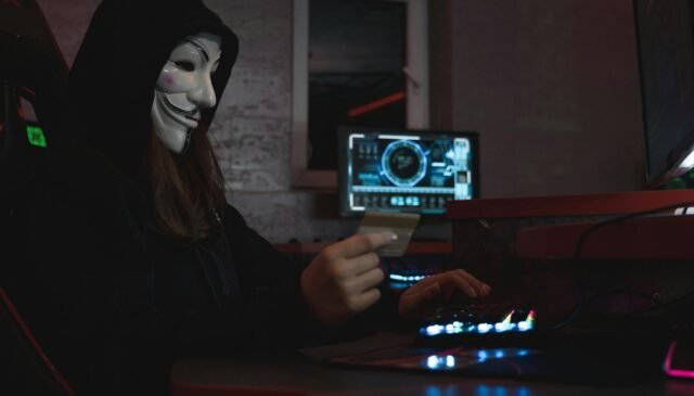 woman in black hoodie holding a bank card
