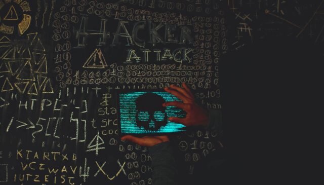 a person holding a tablet device with skull image near blackboard