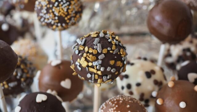 round chocolate coated pastry on white stick