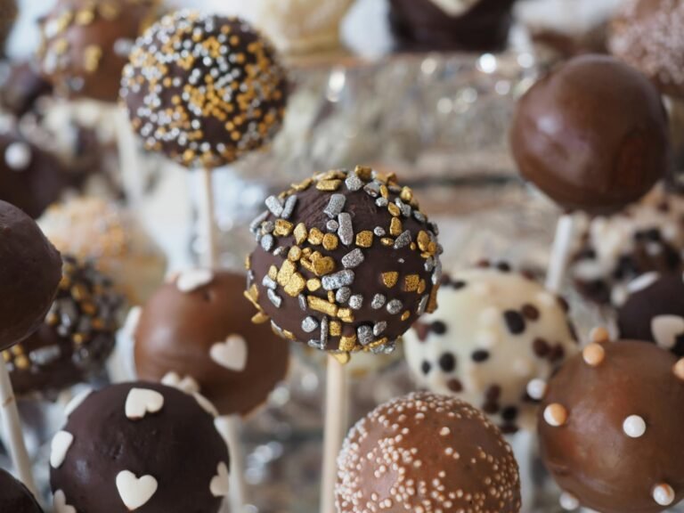 round chocolate coated pastry on white stick