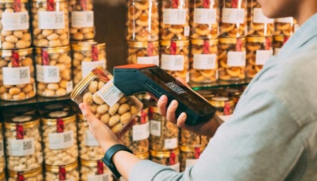 person scanning qr code on jar of pickles