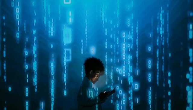 person with smartphone standing in projection of zeros and ones