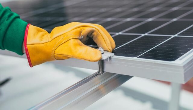 person s hand on solar panel