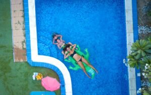 aerial photography of three people swimming