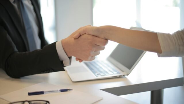 person in black suit hired an employee