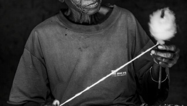man holding thread spool