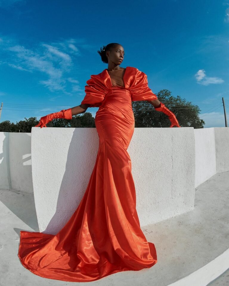 elegant model in vibrant red gown outdoors
