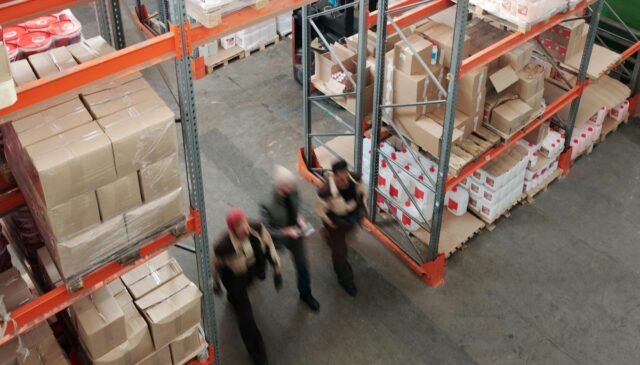 men walking in a warehouse