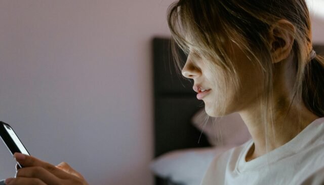 close up shot of a woman using a mobile phone