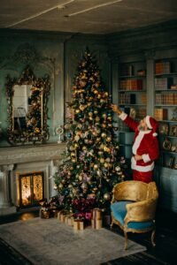 man standing beside christmas tree