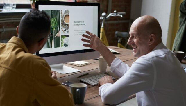 photo of people sitting in front of computer