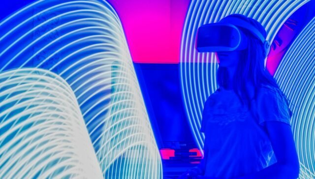blue and pink manipulated image of a girl wearing virtual reality headset