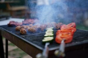 close up of meat and vegetables on a grill