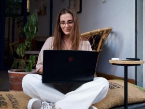 young woman sitting and using a laptop