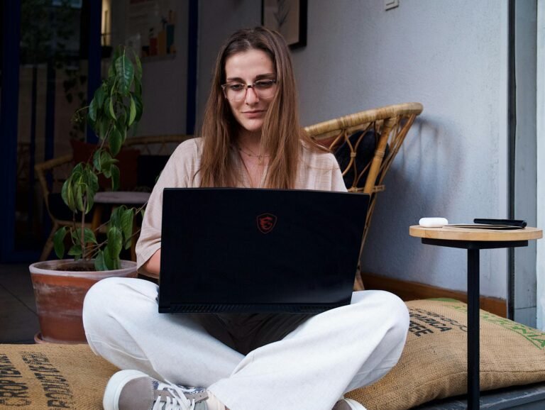 young woman sitting and using a laptop