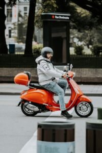 man on motor scooter on street