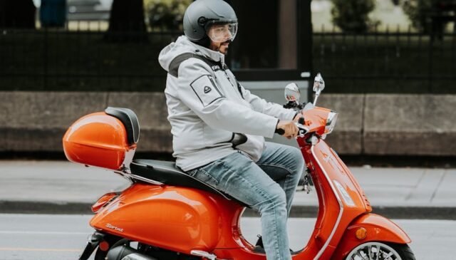 man on motor scooter on street