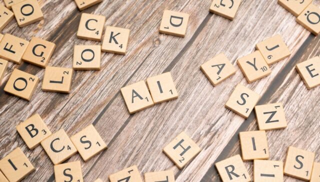 scrabble tiles on a wooden table with the word rock