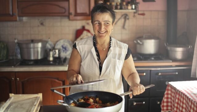 woman wearing apron while smiling