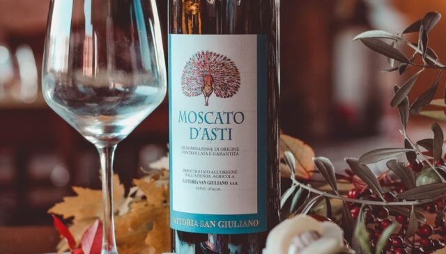 wine bottle beside a clear wine glass