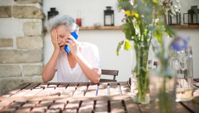 elderly woman crying while on phone call
